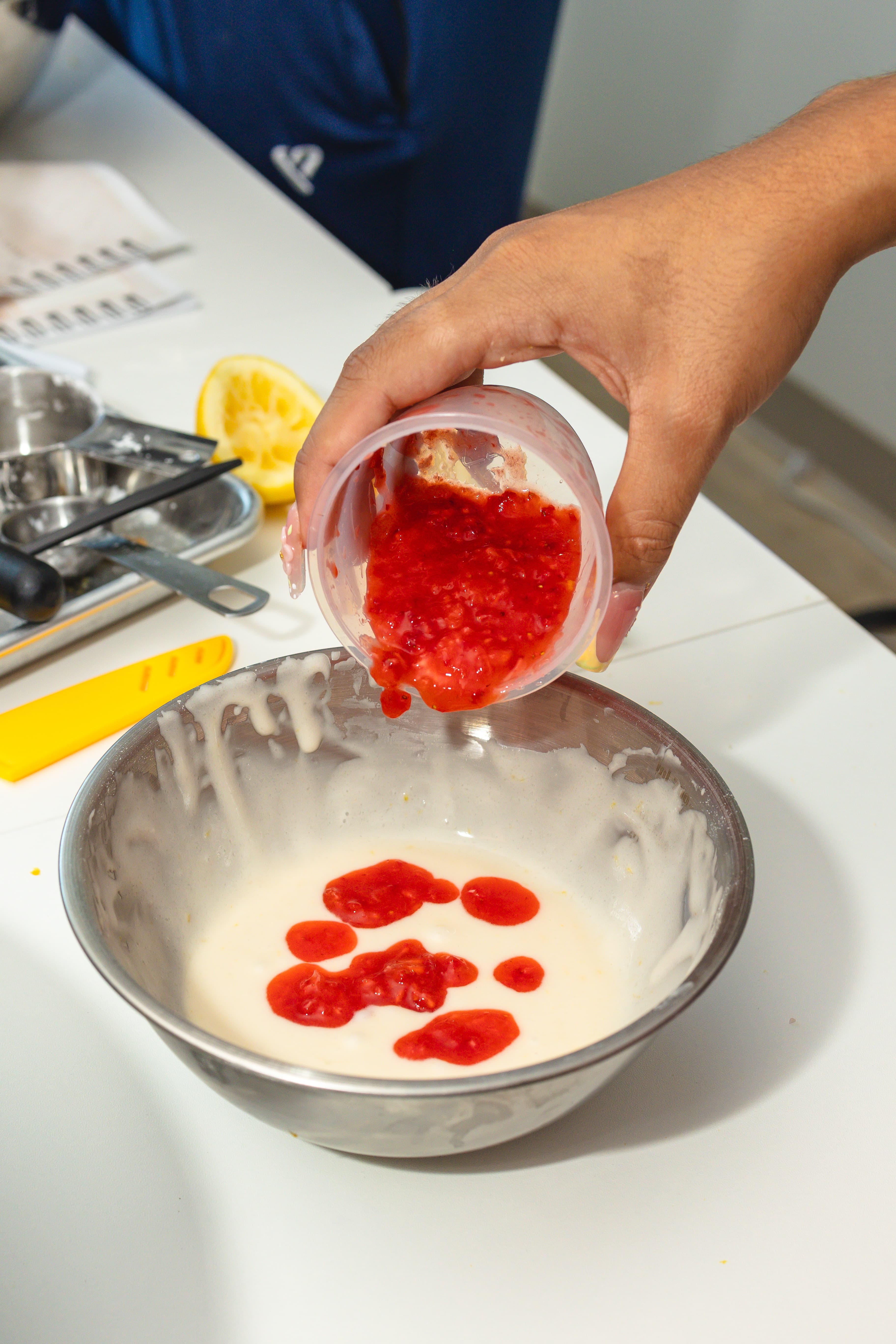 A young cook studies measurements beside bowls and kitchen tools